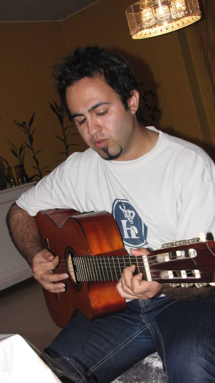 Young Mani Majd playing a classical guitar